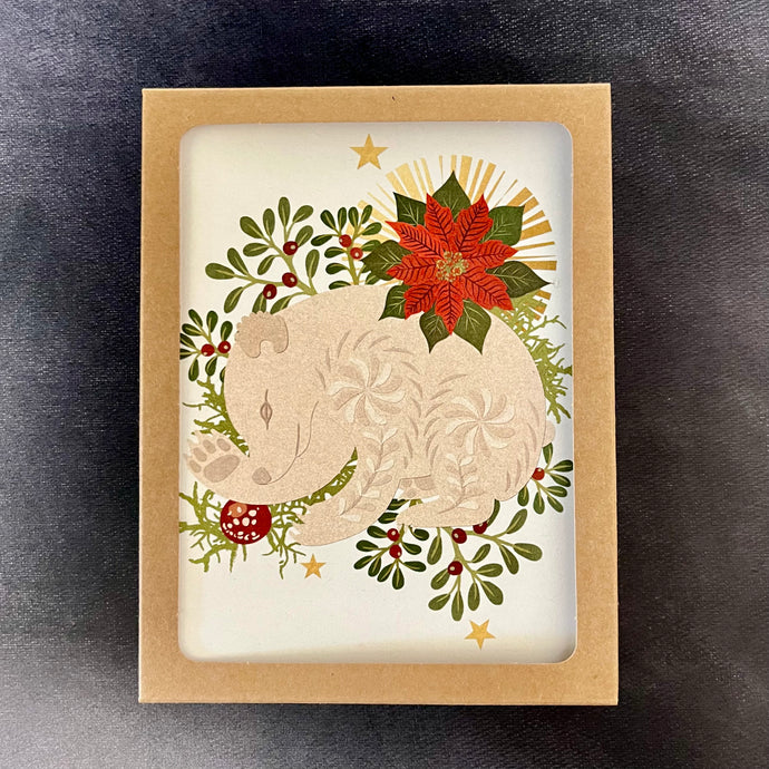 A light kraft box with a viewing window to show the design of the cards inside, the design depicts a white bear on a bed of plants and erries with a red flower above them. Sold at Coyote Supply Co a BIPOC and LGBTQIA+ owned zero waste witch store in Reno Nevada