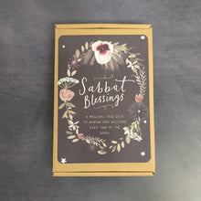 Load image into Gallery viewer, A kraft paper box of Sabbat Blessings cards with a black label. The label reads, Sabbat Blessings A magical card deck to honour and welcome each turn of the wheel. The text is surrounded by a circle of plants and flowers. Sold at Coyote Supply Co a BIPOC and LGBTQIA+ owned zero waste witch store in Reno Nevada